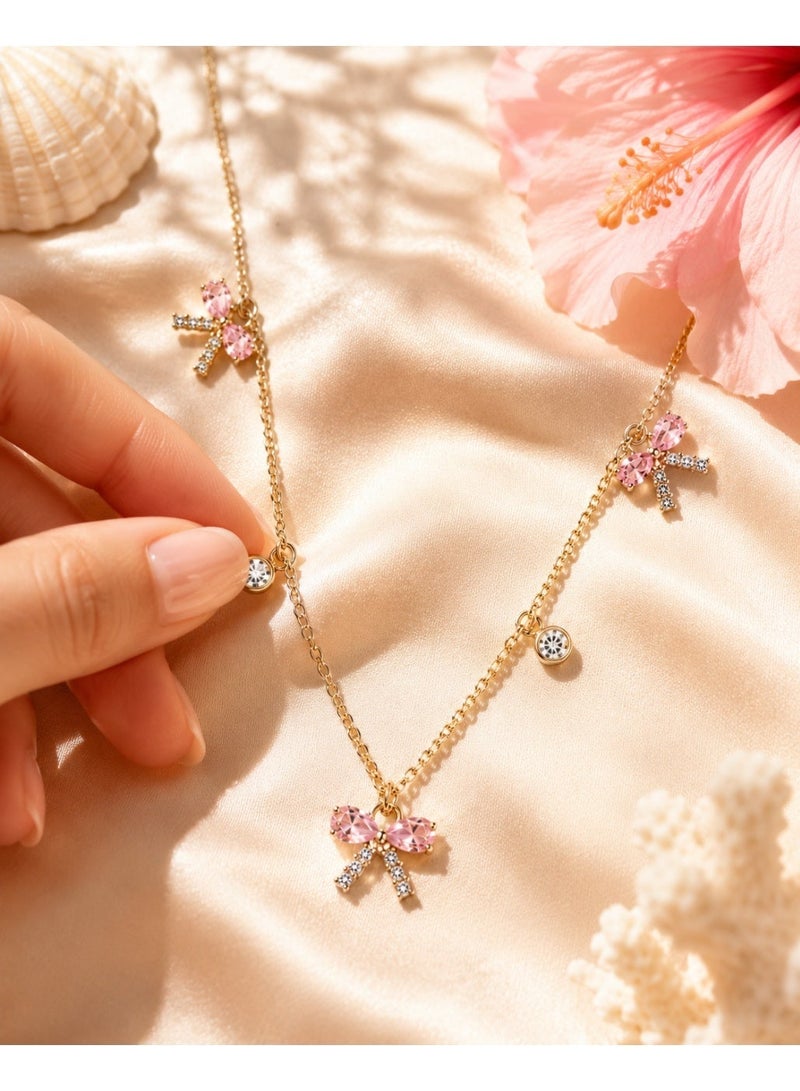 RAFAL Women's Gold-Tone Station Necklace with Three Pink Crystal Bow Charms - Image 2