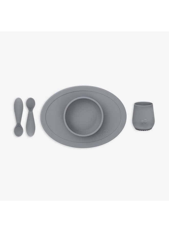 ezpz ezpz First Food Set - 100% Food Grade Silicone Suction Bowl with Built-in Placemat, Training Cup & Spoon - Designed by a Pediatric Feeding Specialist - Promotes Self Feeding - 6 Months+ (Grey)  - Image 1