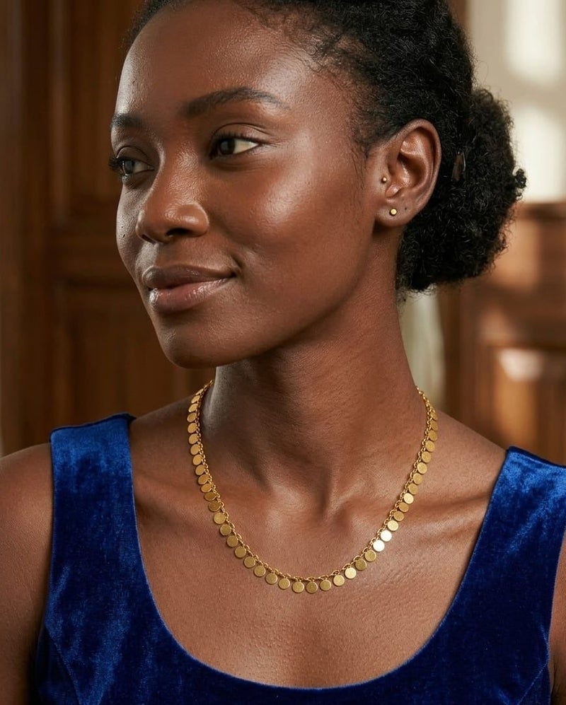 Luxuria An elegant necklace featuring a delicate chain from which hangs a collection of small, solid, round pendants with a pleasing texture; a design that combines Middle Eastern and contemporary styles. - Image 2