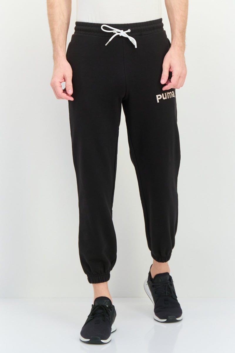PUMA Men Relaxed Fit Outdoor Sweatpants, Black - Image 1