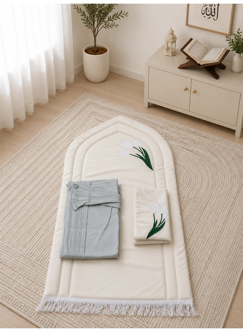 A distinctive Tulip prayer set consisting of a prayer mat with a foam lining in the shape of a mihrab, a plain prayer garment with pleats, and an attached headscarf. One large size for women.