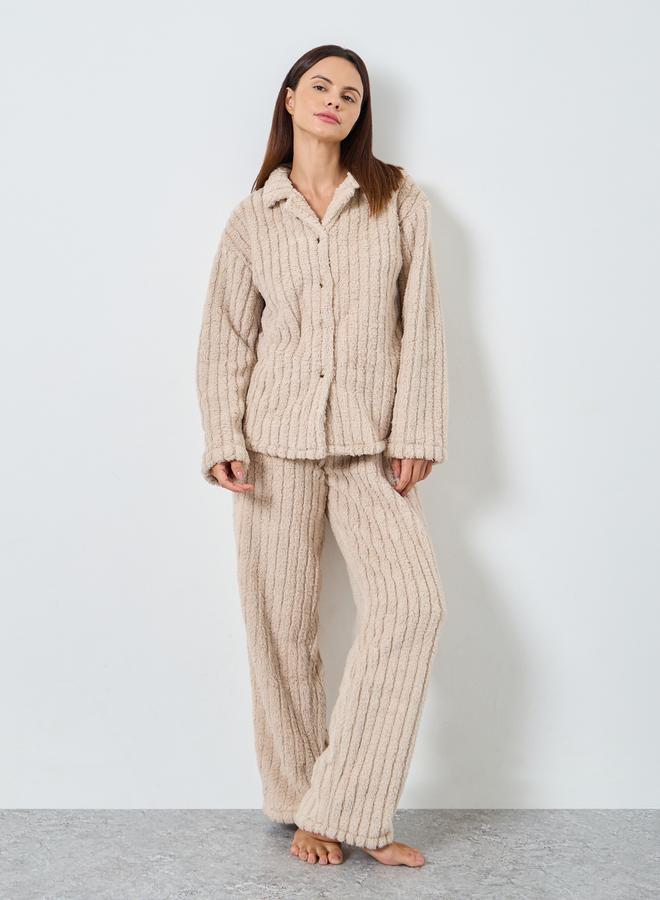 A pajama set of pants and a blouse with a button s...