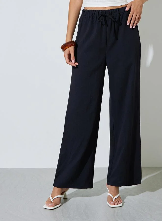 ستايلي Black Solid Elastic Waist Wide Leg Pants