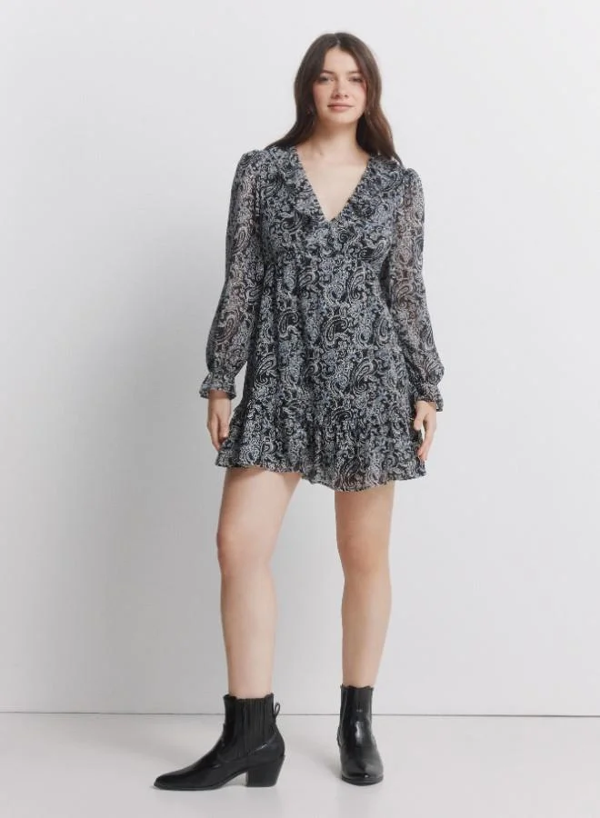 Springfield Printed long sleeve short dress. V-neck with ruffle. Cut below the bust. Skirt with double flounce. Ruffle detail on cuffs.