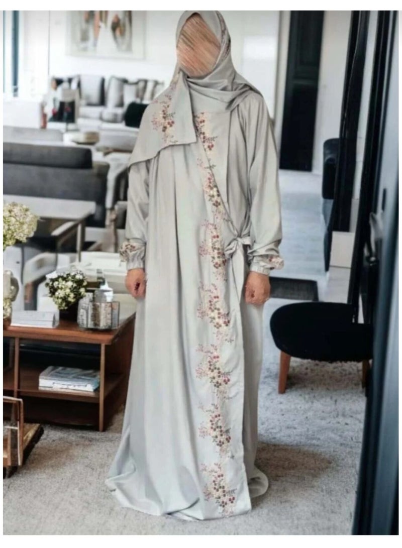 A distinctive prayer shawl made of cool fabric with delicate embroidery. It features a side tie closure and comes in one large women's size. Available in a beautiful gray color, it also includes an attached headscarf with embroidery on both the fabric and the sleeves.