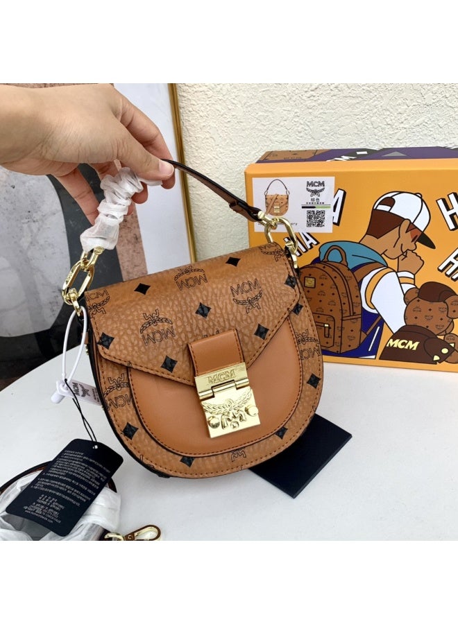 MCM Brown Monogrammed Mini Saddle Crossbody Bag with Top Handle, Gold-tone Lock and Adjustable Strap