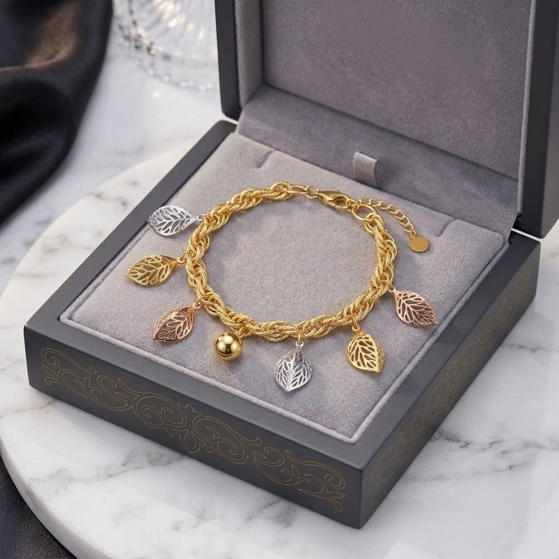 An elegant gold bracelet, with a braided chain and leaf pendants in (silver, rose gold, gold) colors and a shiny gold-colored ball in the middle, with an adjustable clasp to suit you. - Image 4