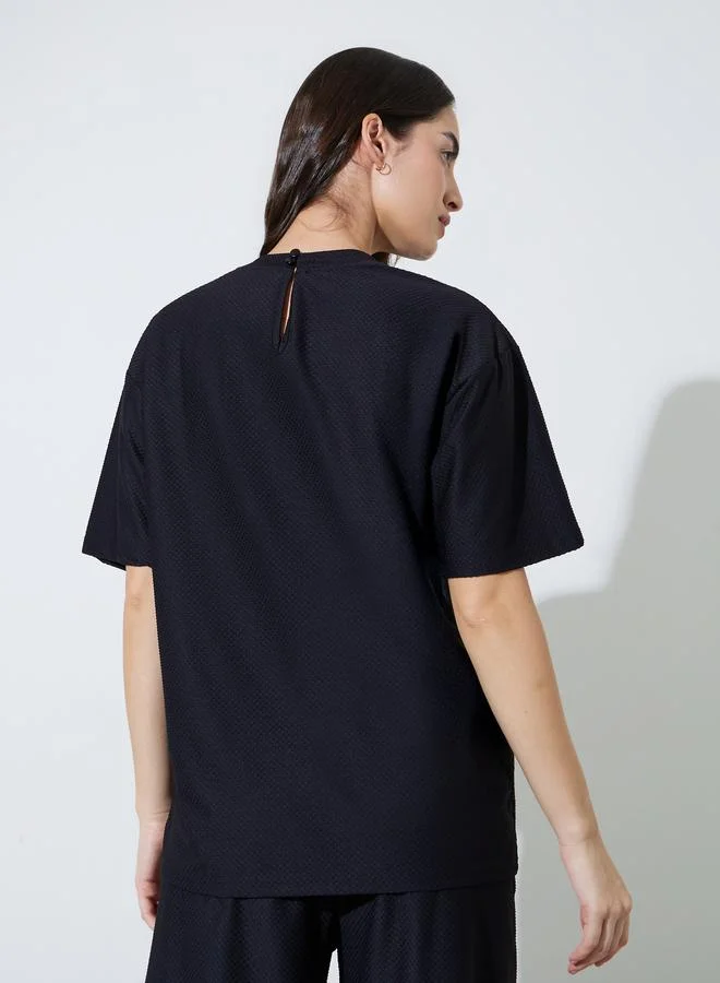 Styli  Black Oversized Textured Round Neck T-Shirt for Women | Best Price UAE