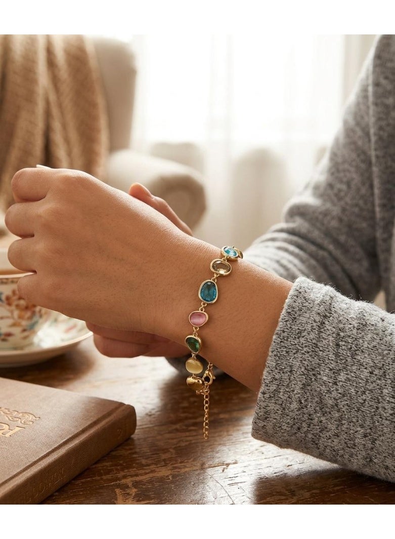 Luxuria An elegant gold bracelet adorned with colorful gemstones in oval and pear shapes, including shades of blue, pink, yellow, and green. - Image 3