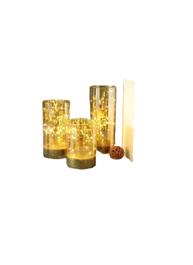 A set of three golden LED decorative glass candles in a box 