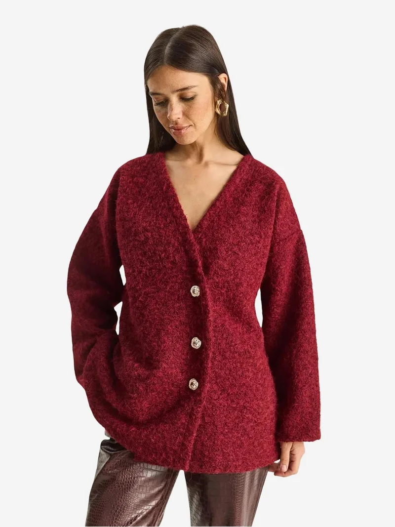 بيانكو لوتشي كارديجان بأزرار وياقة على شكل حرف  من لوتشي بنقوش بارزة