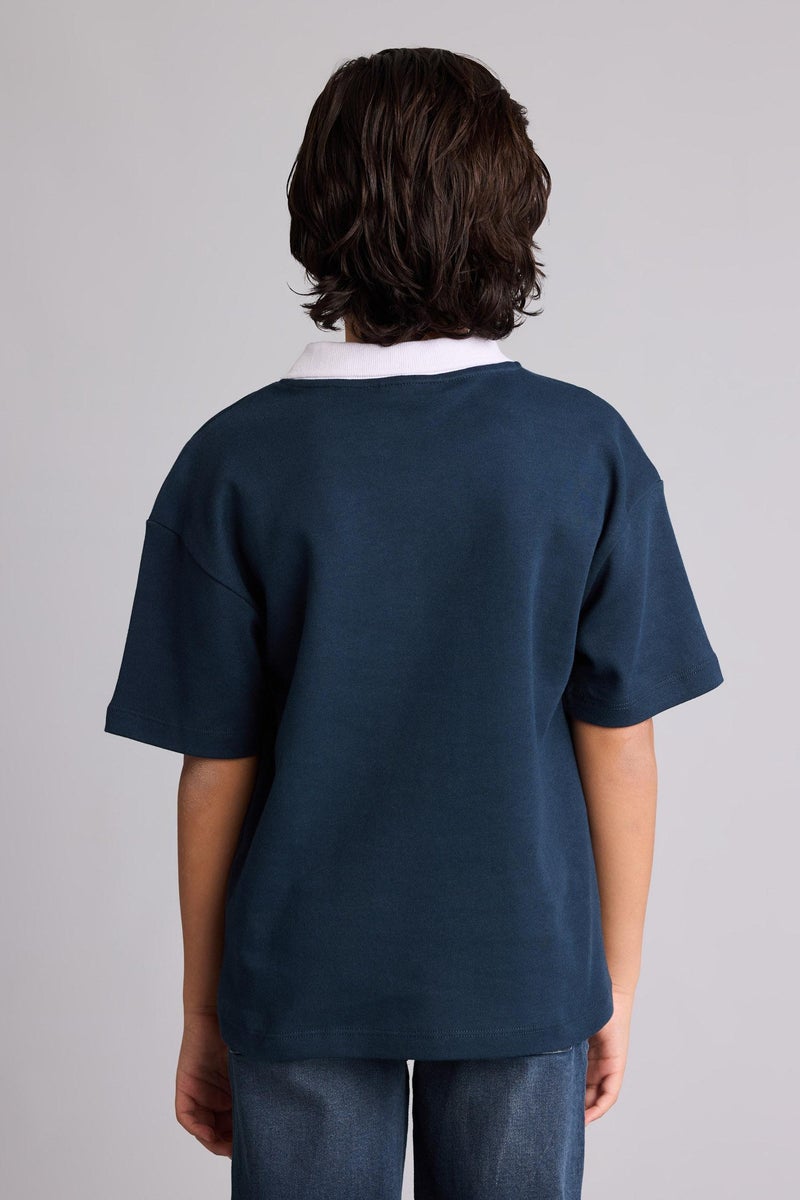 ديفاكتو تيشيرت بولو اولادي نص كم بطبعة شعار اوفر سايز وياقة عالية - Image 5