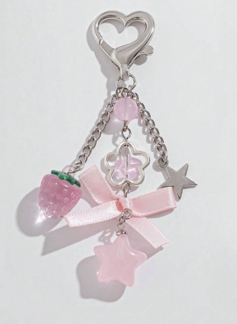 Nevara Stylish keychain with a cute pink design, featuring a heart-shaped clasp and various decorative charms that add a trendy and feminine touch. - Image 1