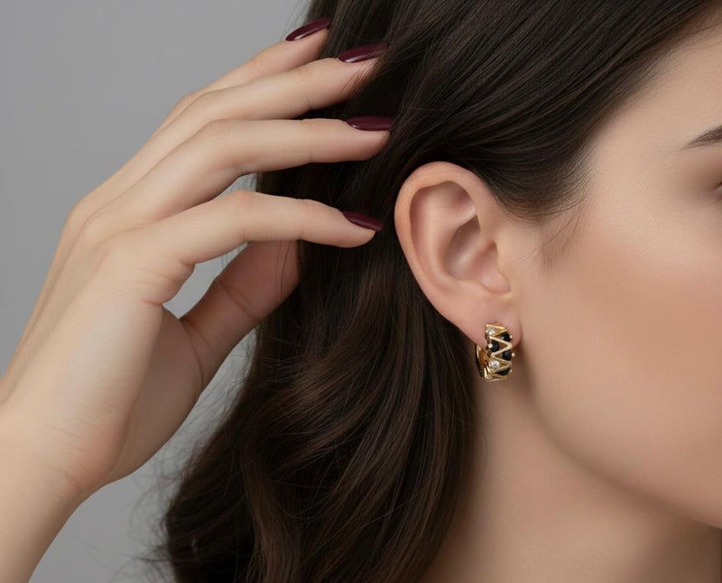 Elegant gold earrings with a modern zigzag design, adorned with round black and silver cubic zirconia stones that give them exceptional sparkle. A bold and distinctive piece that adds a touch of beauty to your look. - Image 5