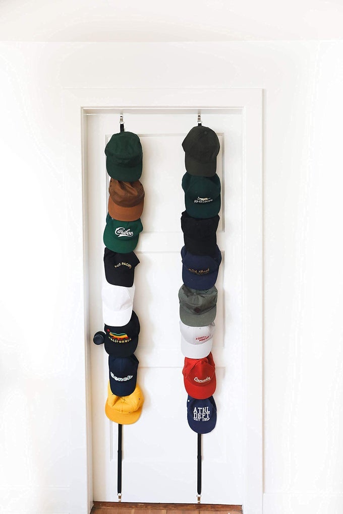 OVER THE DOOR CAP RACK ORGANIZER 2 PACK HOLDS UP TO 16 BASEBALL HATS HAT STORAGE SYSTEM FOR MEN WOMEN AND KIDS ADJUSTABLE CLOSET HANGER WITH HOOKS FOR EASY HAT DISPLAY