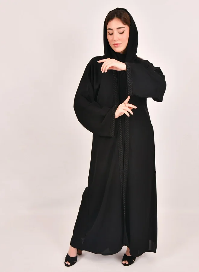 HAWRAA ABAYA Black wrap abaya with a connected dress decorated with spikes on the edges of the abaya and the sleeves