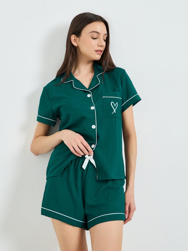 A pajamas set of shorts and a blouse with contrast...