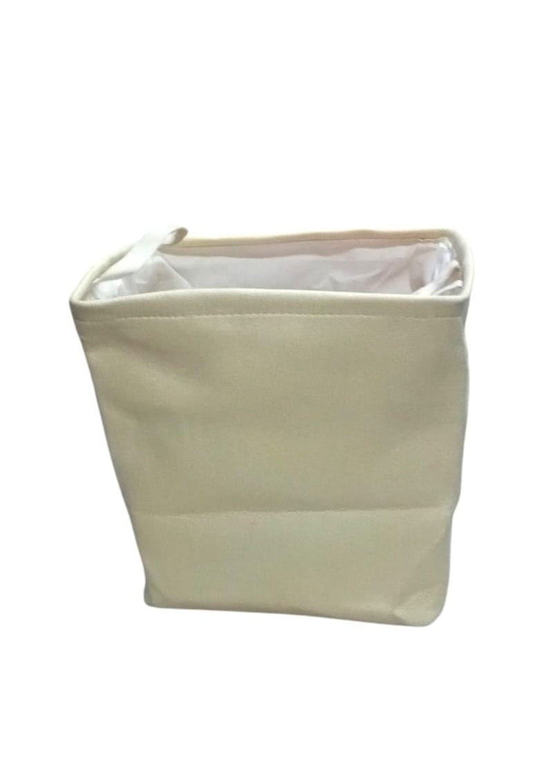 Multi-use canvas storage bag, made of high-quality material in an elegant beige colour. It features a square design with a white inner lining for easy cleaning and protection from dust. Equipped with a side handle for easy carrying and transport. Perfect for organizing clothes, toys, household items, or any other supplies. Adds a tidy and elegant touch to any home or office space.