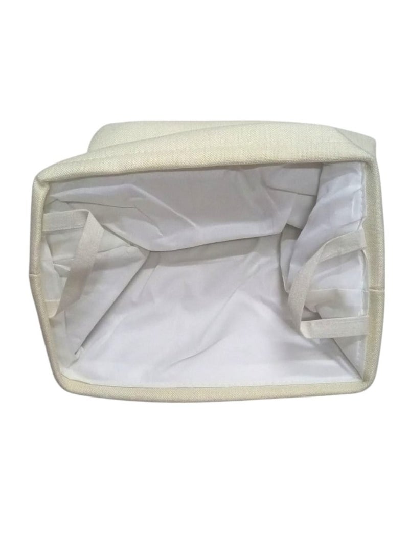 Multi-use canvas storage bag, made of high-quality material in an elegant beige colour. It features a square design with a white inner lining for easy cleaning and protection from dust. Equipped with a side handle for easy carrying and transport. Perfect for organizing clothes, toys, household items, or any other supplies. Adds a tidy and elegant touch to any home or office space.