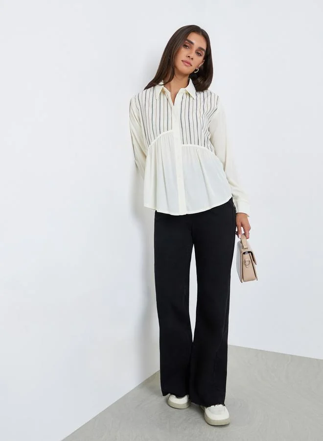 ستايلي بلوزة مخططة بقصة واسعة وأكمام طويلة