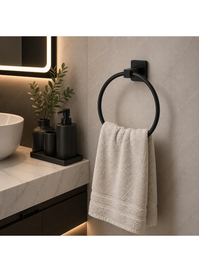 A round, wall-mounted towel rack made of black stainless steel. - Image 2