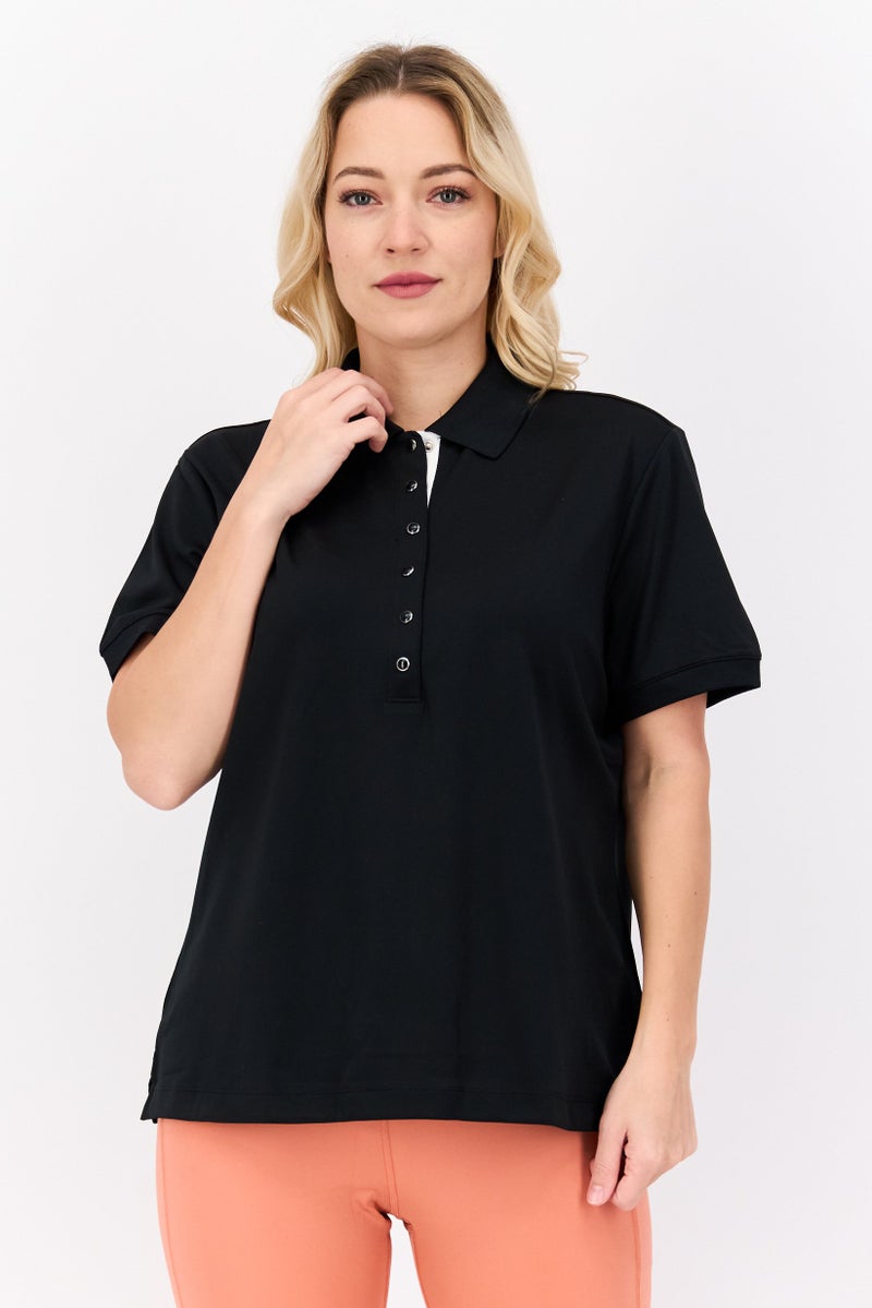 Greg Norman تي شيرت بولو تدريب قصير الأكمام للنساء، أسود - Image 1