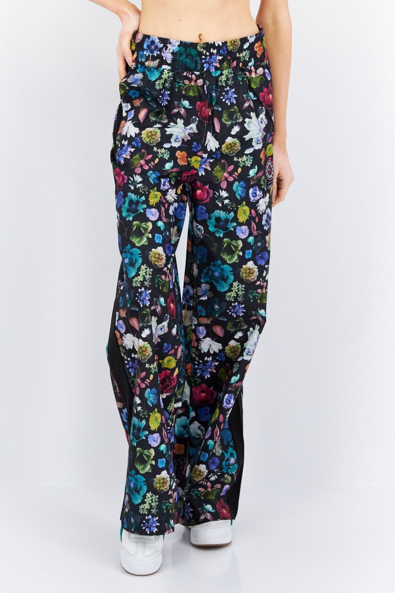 PUMA Women Sportswear Fit Floral Print Outdoor Track Pant, Black Combo - Image 1