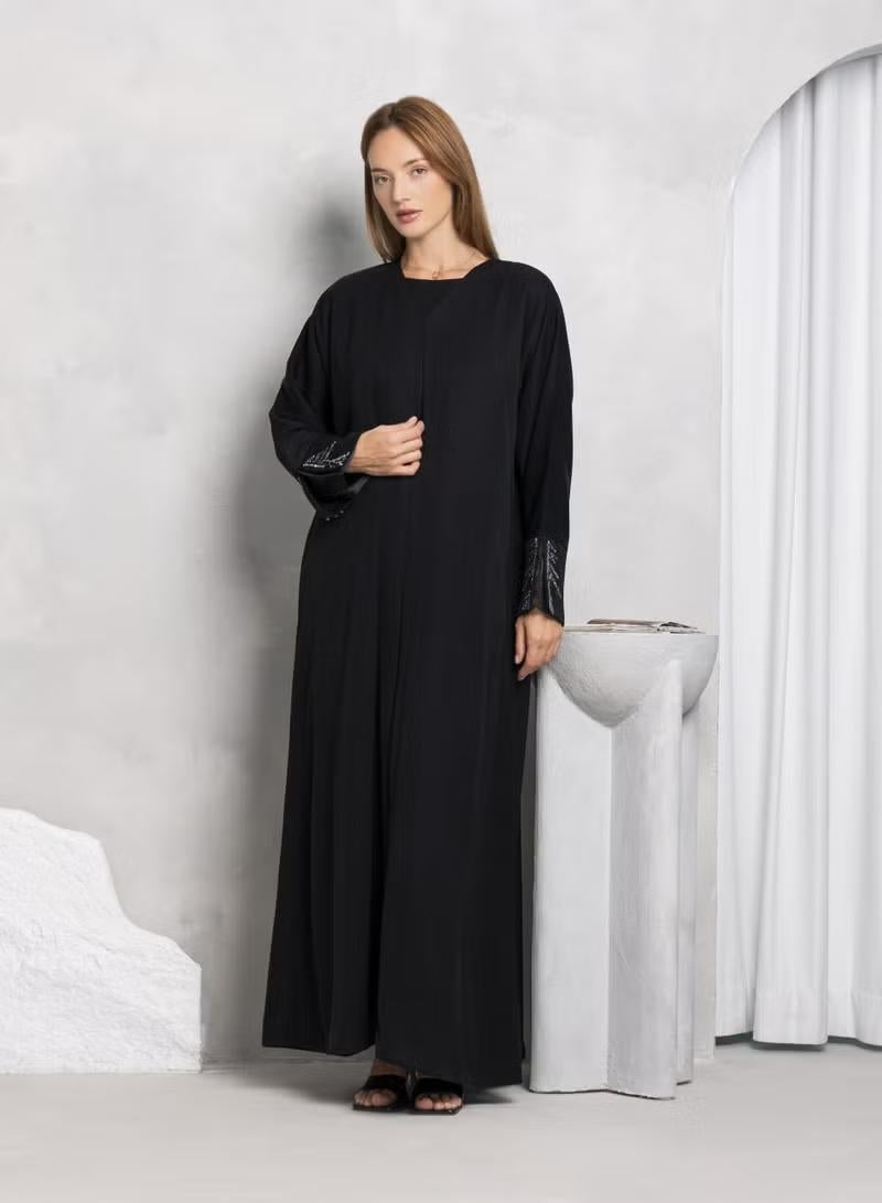 Nikias Black Nida Abaya with pleats & Buttons on Bottom & sleeves - Image 1