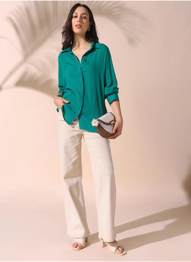 Dennis Lingo Women green oversized solid full sleeves button down rayon shirts with button closure featuring a spread collar- your next go-to for effortless flair.