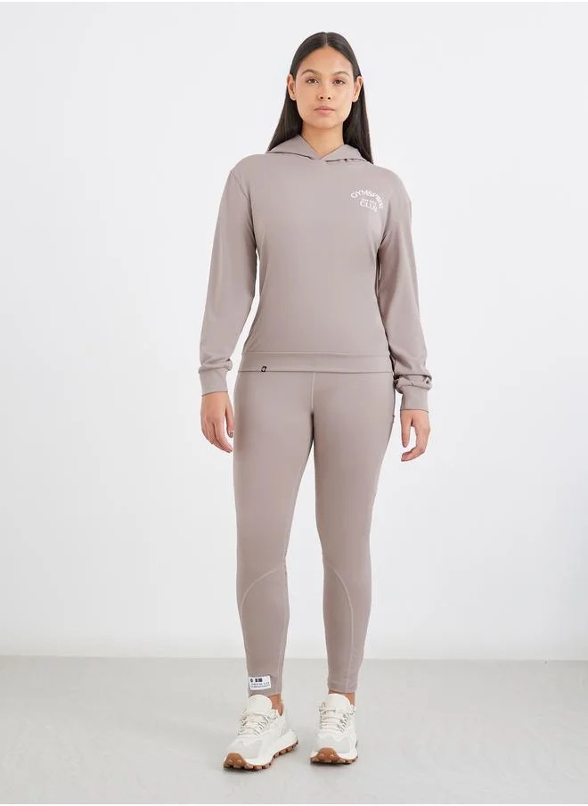 ستايلي Styli Gymspire Edition - Front and Back Text Detail Long Sleeve Hooded Top