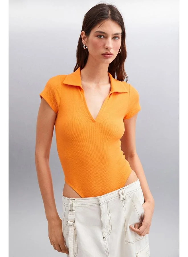 Ethiquet LUAGINA Women's Organic Cotton Ribbed Stretch Fabric Orange Polo Collar Blouse with Snap Buttons.