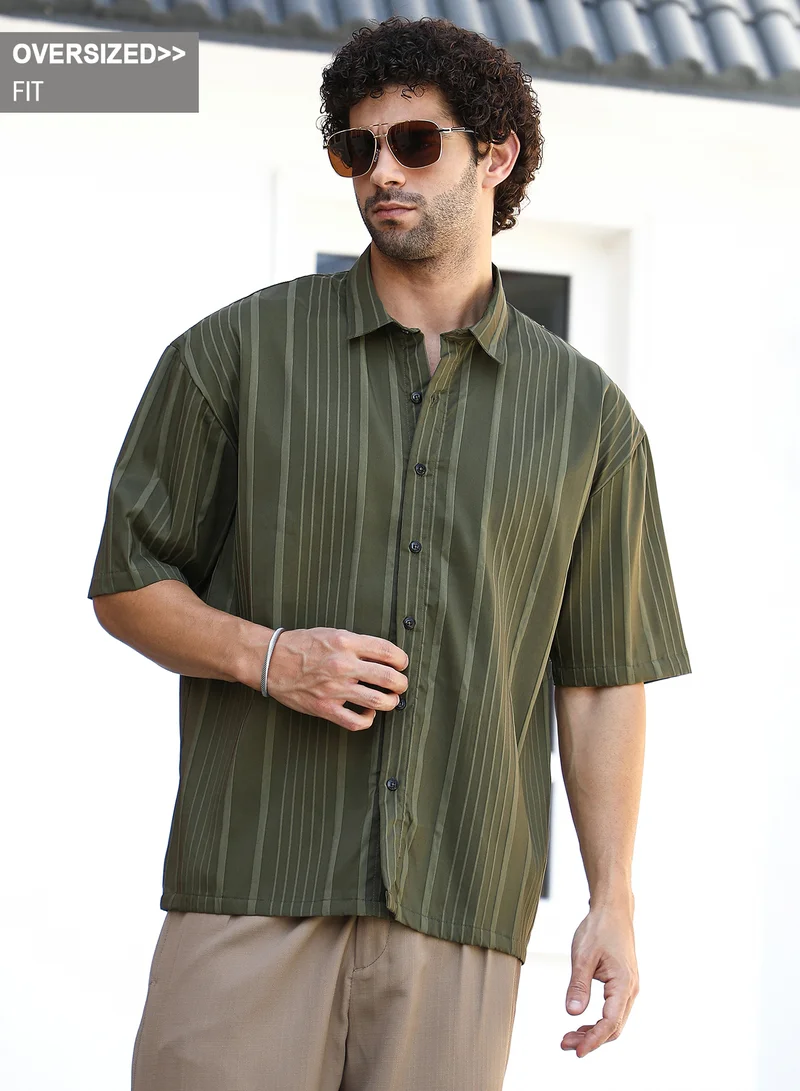 Campus Sutra Campus Sutra Men's Army Green Unbalanced-Ridge Oversized Shirt For Casual Wear | Spread Collar | Short Regular Sleeves | Button Closure | Oversized Shirt Crafted With Comfort Fit For Everyday Wear