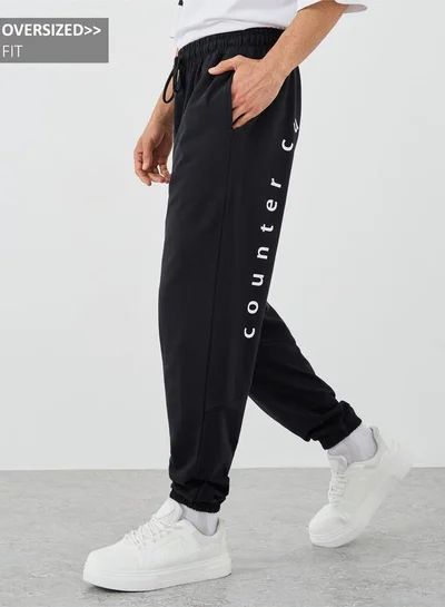 ستايلي بنطلون رياضي واسع بطبعة شعار مع رباط