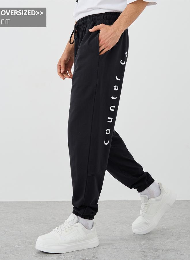 Styli Styli Slogan Print Oversized Joggers with Drawstring  - Image 1