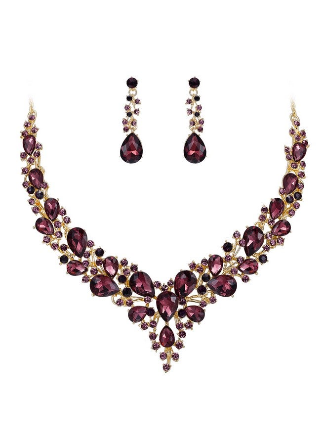 بريلوف طقم مجوهرات للنساء من عقد وأقراط على شكل دمعة من الكريستال النمساوي، طقم أقراط متدلية على شكل دمعة من اللون الجمشتي الداكن مع لمسة ذهبية - Image 1