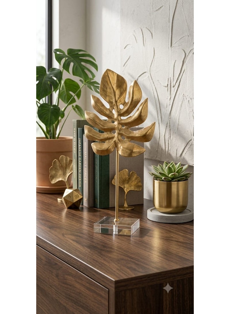 A stunning gold metal decorative piece in the shape of a tropical monstera leaf with a transparent acrylic base - a modern and elegant decoration for tables and bookshelves - Image 1