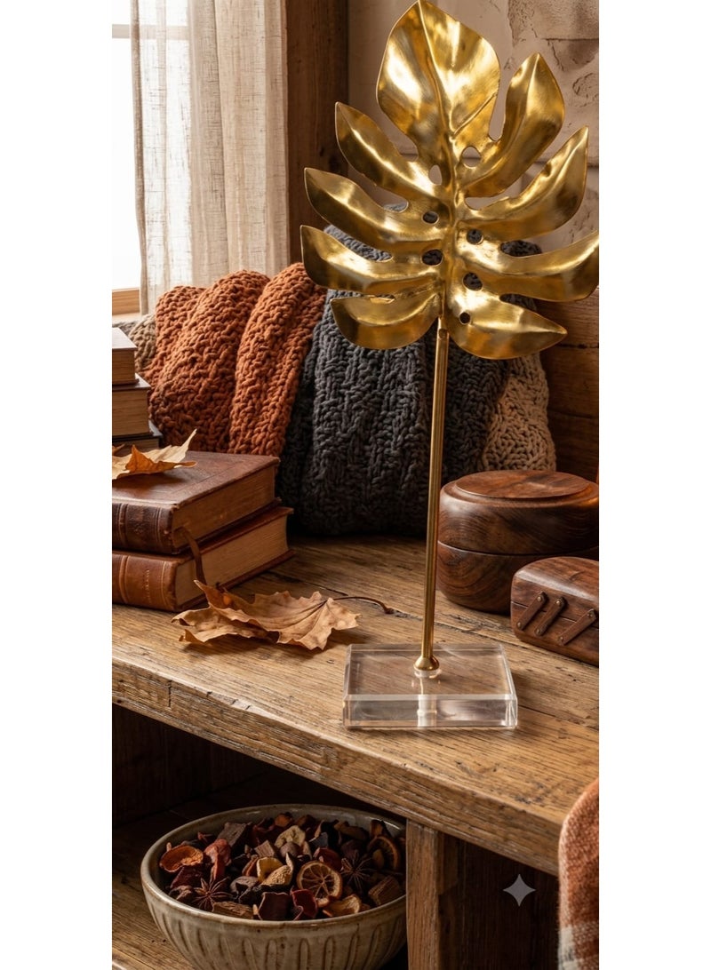 A stunning gold metal decorative piece in the shape of a tropical monstera leaf with a transparent acrylic base - a modern and elegant decoration for tables and bookshelves - Image 3