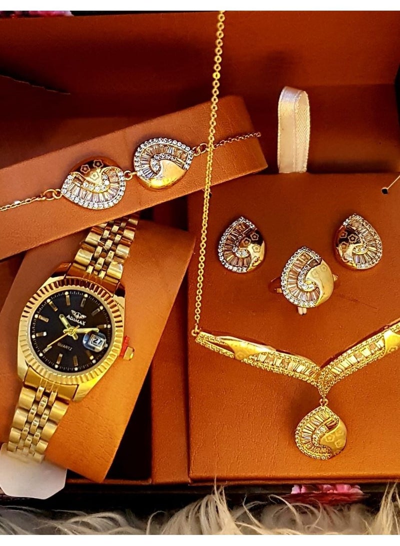 A luxury women's set consisting of a watch and jewelry in golden color