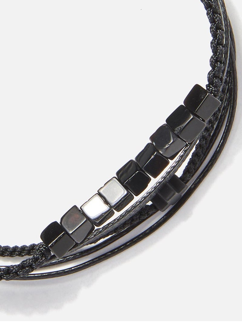 CHRYSOSTOMOS سوار متعدد الخطوط قابل للتعديل مصنوع يدويًا مع هيماتيت أسود لامع مربع، ماكرامي مضفر، حبل أسود وصليب هيماتيت أسود - Image 2