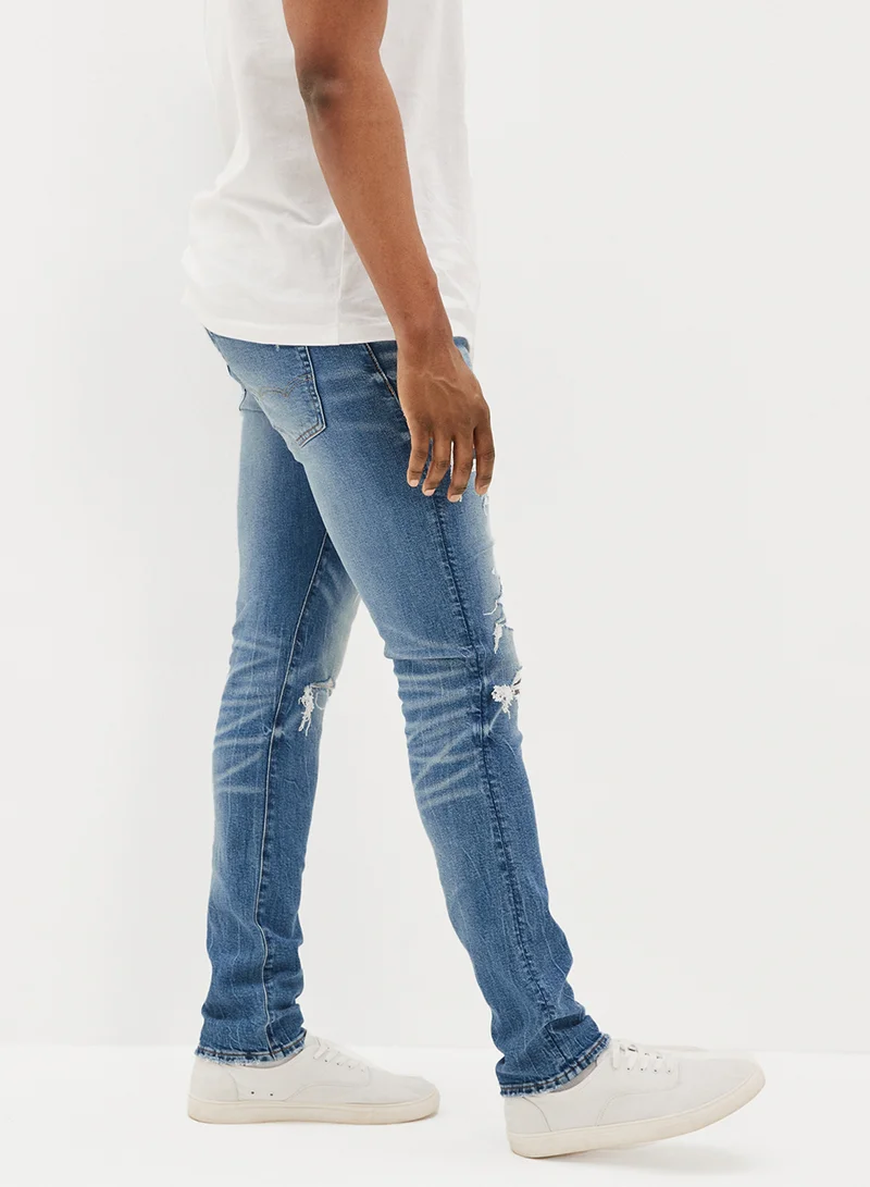 American Eagle Airflex+ Patched Slim Fit Mid Wash Jeans