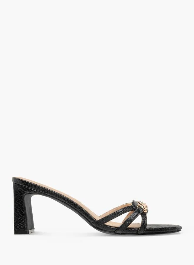 فلورا بيلا من شو إكسبرس صنادل نسائية سهلة الارتداء بكعب عريض وزخرفة شعار