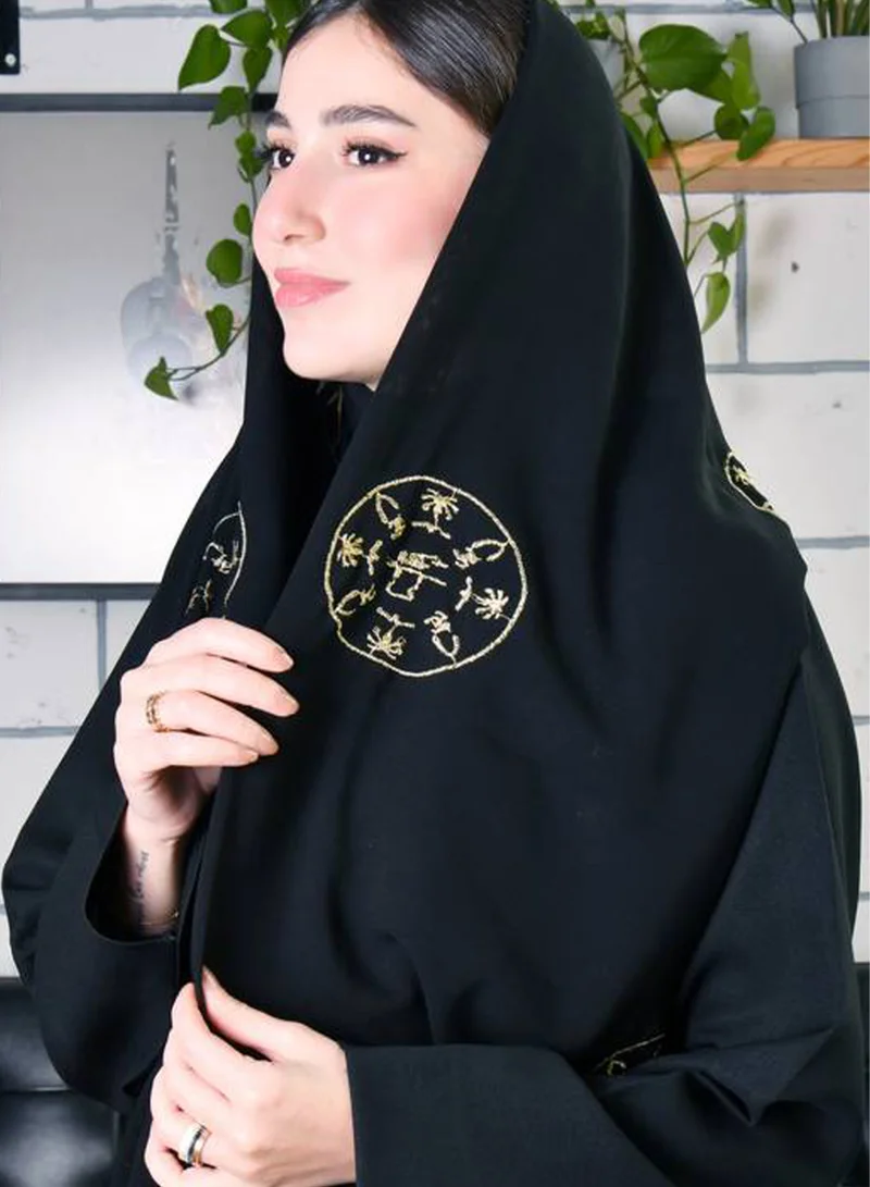 HAWRAA ABAYA Black silk scarf with gold embroidery with the founding logo