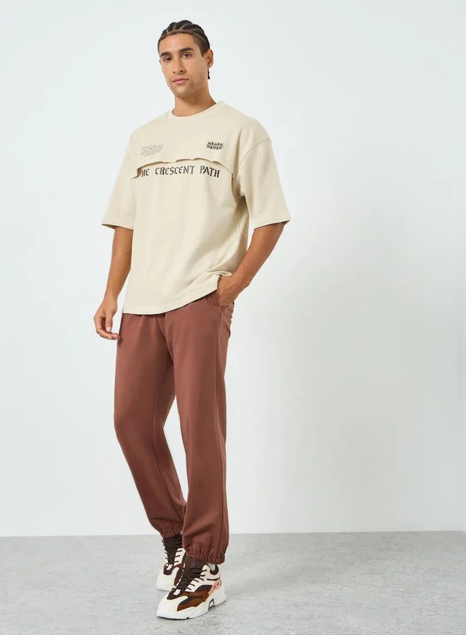 Styli Men Beige Graphic Print Oversized T-Shirt