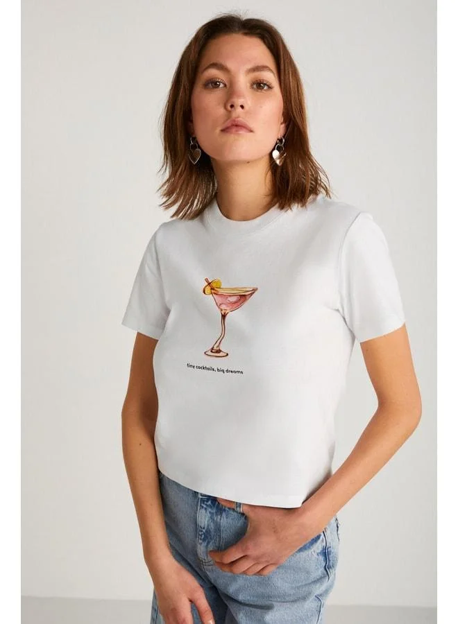 Grimelange Ivonne Women's Cocktail Print Short Sleeve Organic Cotton Bike Neck Crop White T‑shirt.