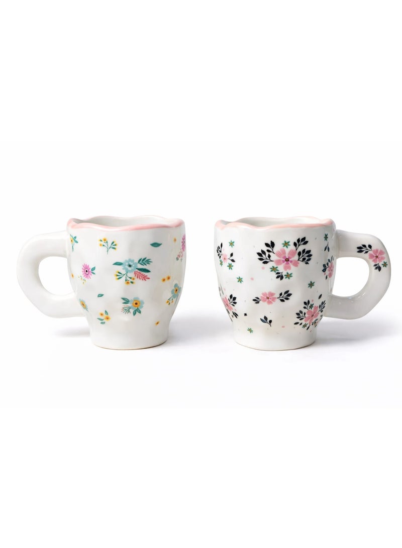 Set of 2 artistic ceramic cups with soft floral and bird designs in a pastel touch on a white background, 300ml capacity per cup, ideal for coffee, latte, or tea with a comfortable handle and elegant design. - Image 1