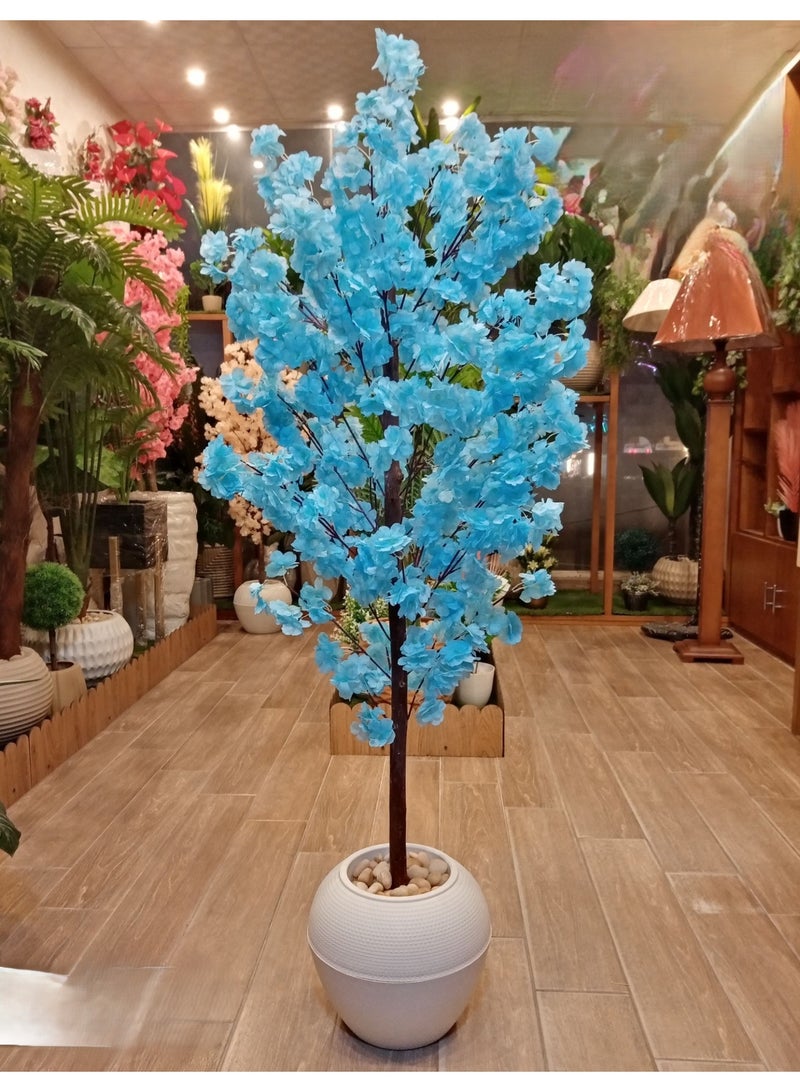 NAMA Artificial blue flowering decorative tree in a white spherical pot.