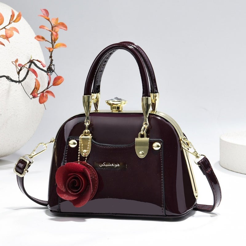 Steel armor mini shell bag, suitable for casual fashion, shiny surface, equipped with floral charm pendant, multi-functional handbag or cross-body bag, fashionable classic, lightweight and durable design