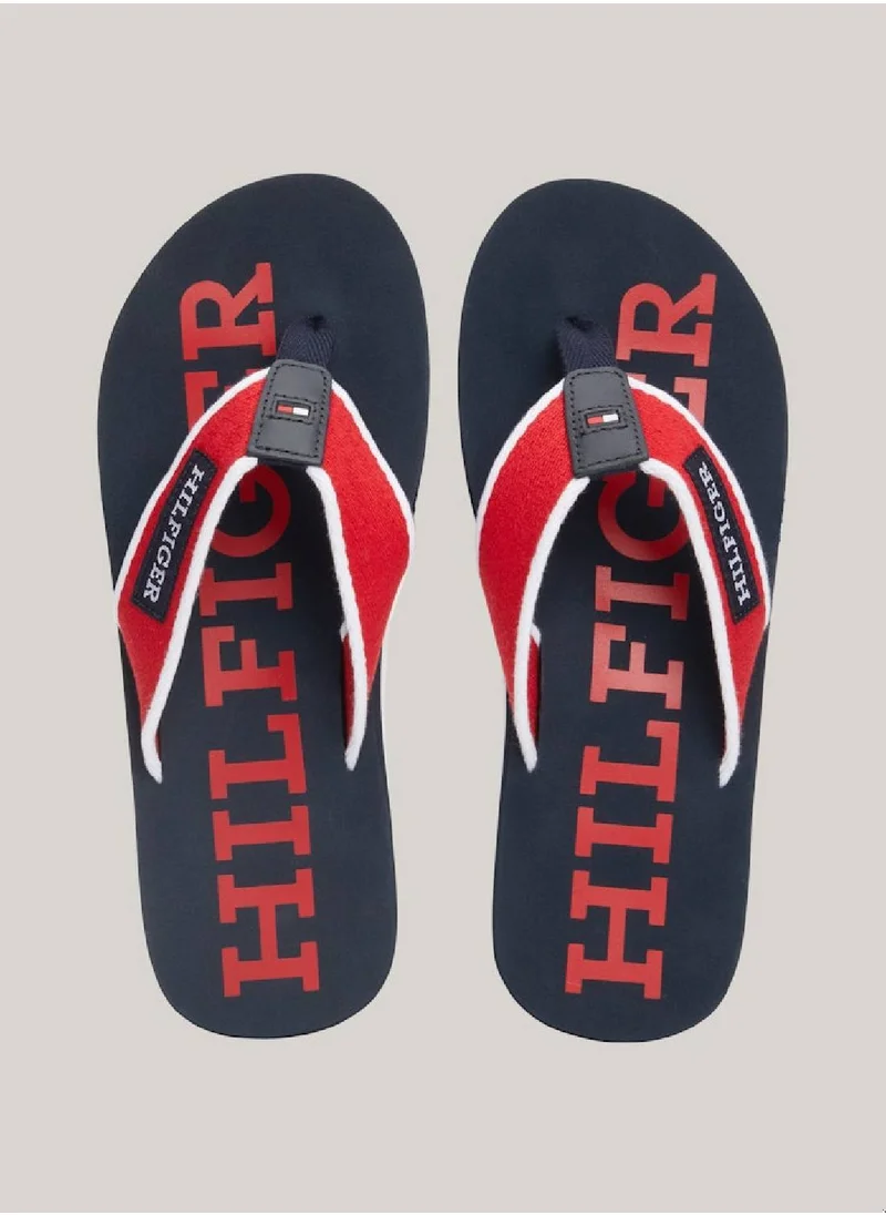 TOMMY HILFIGER Men's Hilfiger Monotype Webbing Strap Flip-Flops -  Polyester webbing upper, Red