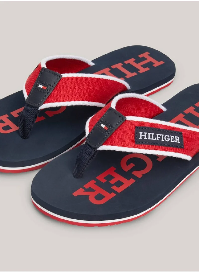 TOMMY HILFIGER Men's Hilfiger Monotype Webbing Strap Flip-Flops -  Polyester webbing upper, Red