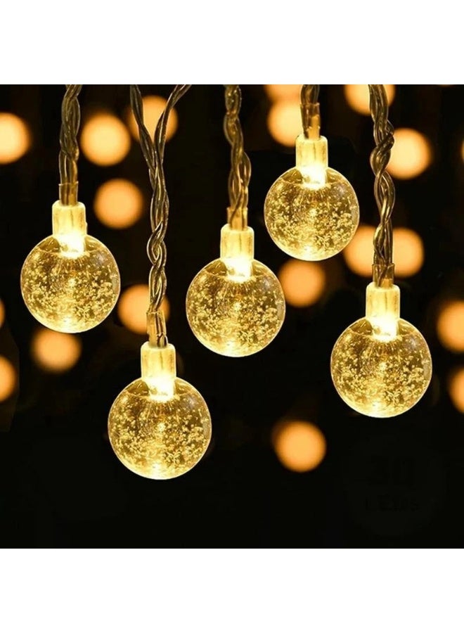 أضواء سلسلة على شكل كرة كريستالية بتقنية LED، أضواء خرافية تعمل بالكهرباء بإضاءة LED صفراء دافئة، 12 مصباح LED، طولها متر واحد، أضواء متلألئة على شكل كرة فقاعية، إكليل زينة مقاوم للماء بمعيار IP66 لأعياد الميلاد ورأس السنة الجديدة وتزيين المنزل - Image 2